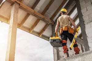 Construction Worker Inspecting the Structure of a Building Under Renovation During Daylight photo