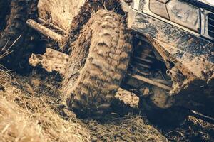 Mud-covered Vehicle Navigating Through Tough Terrain in an Off-Road Adventure Setting photo