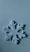 Vertical Winter Background With Toy Snowflake On Light Blue Surface Similar To Ice. Flat Lay Image Of Isolated 3D Snowflake On Frozen Surface photo