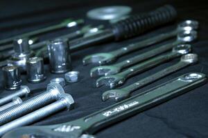 Wrenches, Bolts And Socket Spanners Isolated On Black Inclain Shot photo