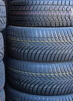 Rubber Surface Texture Of New Winter Tires Stacked In A Pile. Non Studded New Tires For Winter Conditions photo