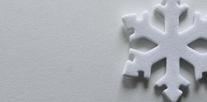 Single Artificial Snowflake Isolated On White With Empty Space Panoramic Image. Winter Greeting Card Design. White 3D Printed Snowflake On White Background photo