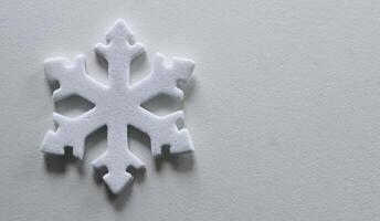 Snowflake Figurine On Clean White Surface Similar To Snow. Snowflake On White With Copy Space Stock Photo
