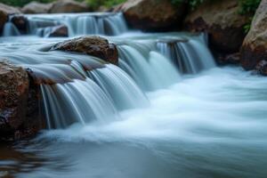 A waterfall flowing over rocks in a river photo