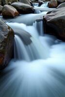 A river flowing over rocks in a stream photo