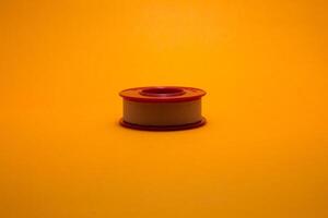 yellow background wound plaster roll photo