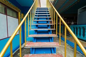 Colorful Staircase with Yellow Railings and Blue Steps in Public Space photo