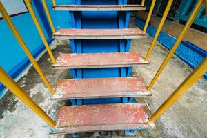 Colorful Staircase with Yellow Railings and Blue Steps in Public Space photo