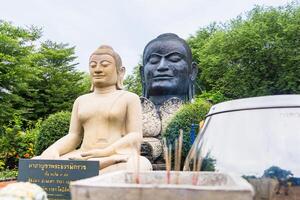 Sacred Thai Buddha Statues with Incense Offerings in a Serene, Green Garden Setting at Ayutthaya, Thailand. photo