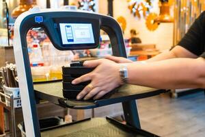Nonthaburi, Thailand - November, 01, 2023 Modern Dining Experience.Robot Serving at BBQ at Nonthaburi, Thailand photo