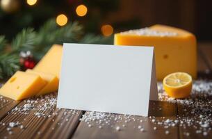 blank greeting card and cheese on wooden table. Christmas decorations photo