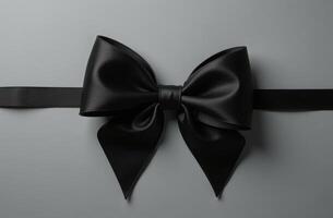 Black bow on grey background. Black Friday concept or luxury card photo