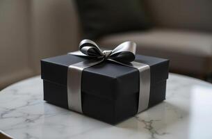 Elegant black gift box with silver ribbon on marble table for special occasions photo
