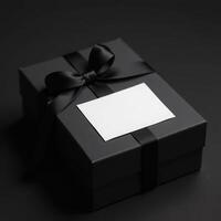 Elegant black gift box with blank card on dark background. black friday photo