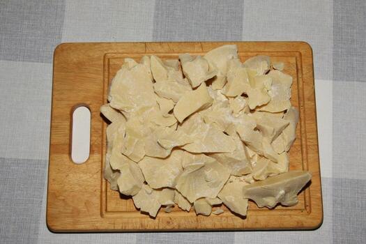 Cocoa butter background, top view, texture. Cocoa butter is one of the ingredients in making chocolate at home. Close-up of crushed cocoa butter, top view. photo