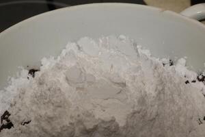 Powdered sugar in a container for making chocolate. photo