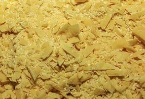 Cocoa butter background, top view, texture. Cocoa butter is one of the ingredients in making chocolate at home. Close-up of crushed cocoa butter, top view. photo