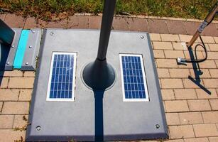 Solar panels in the bike park. Alternative energy source. Energy crisis. photo