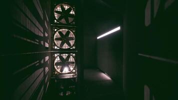Exploring a dark concrete corridor in an industrial building with large fans video