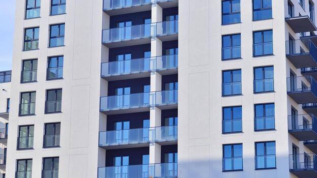 moderno Alto Departamento edificio en blanco, estar alto en contra un azul cielo, ejemplificando innovador urbano arquitectura con pulcro, angular diseños foto