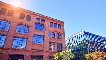 Modern loft building from red brick in downtown area. Industrial design in city architecture. Business concept. photo