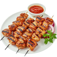 Chicken skewers with sauce on a white plate png