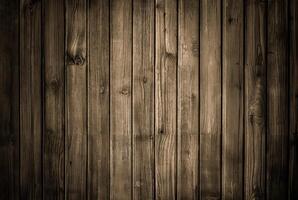 Rustic wooden plank wall with dark tones and visible vertical grain texture, ideal for backgrounds and wood-themed designs. photo