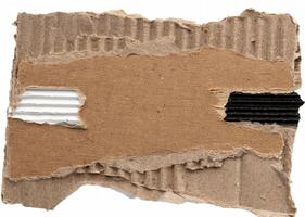 Close-up of torn corrugated cardboard with rough edges and visible texture, ideal for backgrounds and craft designs. photo