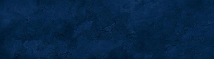 Close-up of a dark blue textured stone surface with subtle patterns and natural marbling, ideal for backgrounds. photo