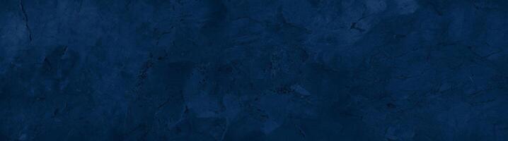 Close-up of a dark blue textured stone surface with subtle patterns and natural marbling, ideal for backgrounds. photo