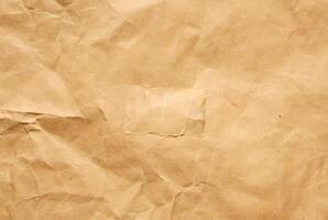 High-resolution brown paper texture with natural creases and subtle wrinkles. photo