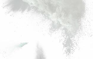 Light gray powder explosion on a white background, creating a soft and airy texture, ideal for abstract designs. photo