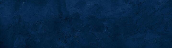 Close-up of a dark blue textured stone surface with subtle patterns and natural marbling, ideal for backgrounds. photo