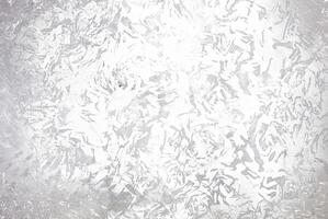 Abstract silver metallic textured background with brushed, irregular patterns, ideal for use in design projects, backgrounds, or as an overlay. photo