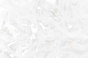 High-resolution close-up of crumpled transparent plastic sheet texture, ideal for use in packaging, backgrounds, or abstract design concepts. photo