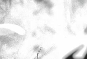 An abstract texture with an overexposed appearance, showing faint shadows in soft, indistinct forms. photo