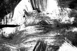 Abstract black and white grunge texture with rough brush strokes and splatters, ideal for backgrounds or artistic designs. photo