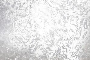 Abstract silver metallic textured background with brushed, irregular patterns, ideal for use in design projects, backgrounds, or as an overlay. photo
