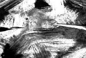 Abstract black and white grunge texture with rough brush strokes and splatters, ideal for backgrounds or artistic designs. photo