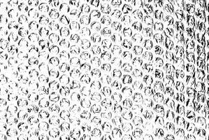 High-contrast black and white bubble wrap texture, featuring circular patterns and crinkled details. photo