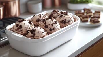 Scoops of creamy chocolate chip cookie dough ice cream await enjoyment on a sunny day photo