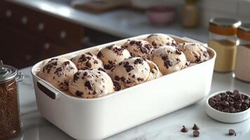 Indulge in creamy ice cream adorned with chocolate morsels on a beautiful countertop photo