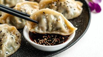 Enjoying delicate dumplings alongside a rich, flavorful dipping sauce photo