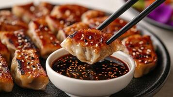 Golden-brown dumplings are enjoyed with fragrant soy sauce and sesame seeds photo