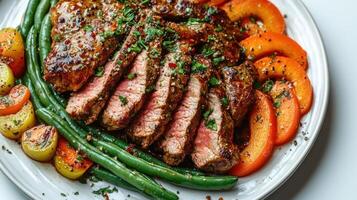 Succulent grilled steak served with colorful roasted vegetables and herbs photo