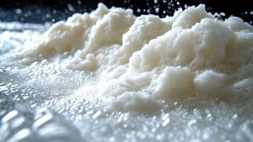 Frothy bubbles rise dramatically and spill over, creating a playful kitchen moment photo