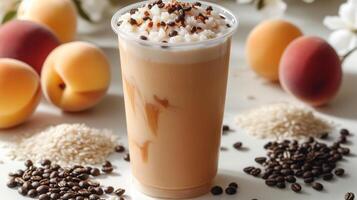 A refreshing iced coffee adorned with cocoa and rice, surrounded by fresh peaches photo
