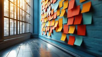 Vibrant sticky notes cover a wall, reflecting creativity in a bright, open office photo