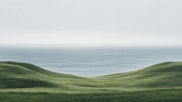 A beautiful, serene scene that showcases gentle hills gradually leading down to a calm ocean, all enveloped in soft light, surrounded by lush natural greens that create a tranquil atmosphere photo