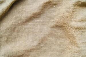 This elegant soft gold fabric background features a subtle but captivating texture ideal for design projects photo